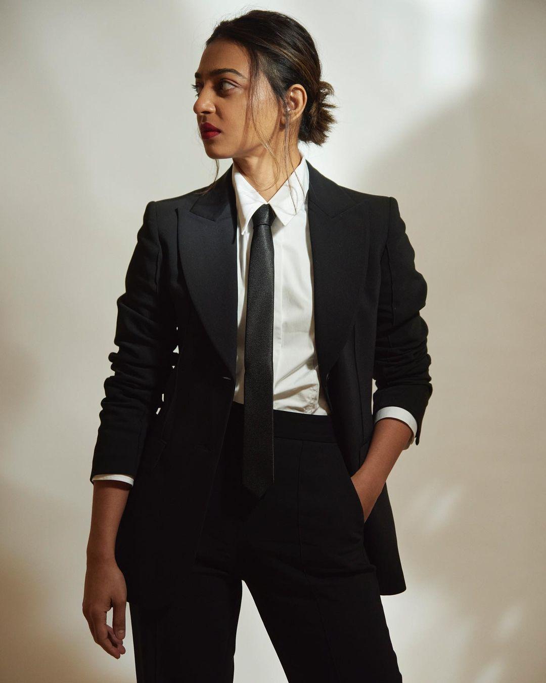 The tailored suit drapes her figure with an air of ease, accentuating her natural grace. With the addition of the black tie, Radhika adds a dash of timeless Hollywood charm to her look, effortlessly blending casual and formal elements.